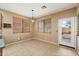 Bright dining area features tile flooring, neutral walls, window coverings and door to outdoor patio at 1392 E Baker Dr, San Tan Valley, AZ 85140