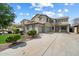 Charming two-story home showcasing desert landscaping, a spacious driveway, and a welcoming facade, inviting you to explore further at 1392 E Baker Dr, San Tan Valley, AZ 85140