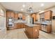 Well-equipped kitchen with granite countertops, stainless steel appliances, a kitchen island, and ample cabinet space for storage at 1392 E Baker Dr, San Tan Valley, AZ 85140
