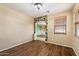 Bright living room featuring hardwood floors, natural light, and an archway leading to another room at 1392 E Baker Dr, San Tan Valley, AZ 85140