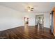 Spacious living room with wood-look flooring, neutral paint and arched entryways to other rooms at 1392 E Baker Dr, San Tan Valley, AZ 85140
