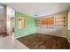 Bright and airy living room with hardwood flooring, built-in shelving, and large windows that let in plenty of natural light at 1392 E Baker Dr, San Tan Valley, AZ 85140