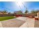 Inviting backyard featuring a built-in BBQ, fire pit, string lights, and artificial turf for entertaining at 272 N 167Th Ln, Goodyear, AZ 85338