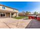 Spacious backyard featuring an outdoor kitchen, artificial turf, and ample patio space at 272 N 167Th Ln, Goodyear, AZ 85338