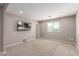 Spacious bonus room featuring a mounted television and ample natural light, perfect for entertainment at 272 N 167Th Ln, Goodyear, AZ 85338