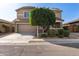 Charming two-story home with mature landscaping, a two-car garage, and a well-manicured lawn at 272 N 167Th Ln, Goodyear, AZ 85338