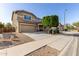 Two-story home featuring a well-maintained lawn, mature tree, two-car garage, and inviting curb appeal at 272 N 167Th Ln, Goodyear, AZ 85338