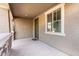 Covered front porch with stone accents, providing a welcoming entrance to the home at 272 N 167Th Ln, Goodyear, AZ 85338