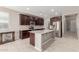 Modern kitchen with granite countertops, stainless steel appliances, and dark wood cabinetry at 272 N 167Th Ln, Goodyear, AZ 85338