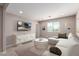 Bright living room boasts modern decor, a large sectional sofa, and a wall-mounted television at 272 N 167Th Ln, Goodyear, AZ 85338