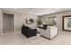 Bright living room features tile flooring, a ceiling fan, and comfortable seating at 272 N 167Th Ln, Goodyear, AZ 85338