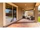 Covered patio with comfortable seating, overlooking the landscaped backyard, perfect for relaxing at 272 N 167Th Ln, Goodyear, AZ 85338