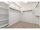 Spacious walk-in closet with built-in shelving and ample hanging space, perfect for organization at 272 N 167Th Ln, Goodyear, AZ 85338
