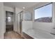 Bathroom features a soaking tub, shower, and window at 18424 W Monte Lindo Ln, Surprise, AZ 85387