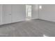 Large bedroom with carpet and access to bathroom at 18424 W Monte Lindo Ln, Surprise, AZ 85387