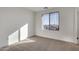 Well-lit bedroom with neutral walls and carpet flooring at 18424 W Monte Lindo Ln, Surprise, AZ 85387