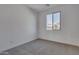 Simple bedroom with neutral walls and carpet at 18424 W Monte Lindo Ln, Surprise, AZ 85387