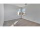 Bright bedroom with neutral carpeting and large window at 18424 W Monte Lindo Ln, Surprise, AZ 85387