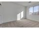 Bright bedroom featuring neutral walls and carpet at 18424 W Monte Lindo Ln, Surprise, AZ 85387