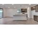 Modern kitchen with island, stainless steel appliances, and ample cabinet space at 18424 W Monte Lindo Ln, Surprise, AZ 85387