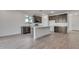 Modern kitchen with dark cabinets, island, and stainless steel appliances at 18424 W Monte Lindo Ln, Surprise, AZ 85387