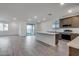 Open kitchen features an island and stainless steel appliances at 18424 W Monte Lindo Ln, Surprise, AZ 85387
