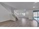Open concept living room and kitchen with wood-look tile floors at 18424 W Monte Lindo Ln, Surprise, AZ 85387