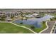 Aerial shot of a neighborhood lake with walking path, pool and recreation area surrounded by homes at 22788 E Orion Way, Queen Creek, AZ 85142