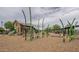 Community playground with a farmhouse themed play structure, slide, climbing elements and other play features at 22788 E Orion Way, Queen Creek, AZ 85142