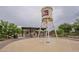 Water tower themed splash pad and playground area in a community park with picnic tables and shade at 22788 E Orion Way, Queen Creek, AZ 85142