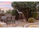 Peaceful backyard patio with seating area, landscaping, and water feature at 35518 N 30Th Dr, Phoenix, AZ 85086