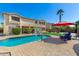 Spacious backyard with a sparkling pool, grassy area, and outdoor entertainment space at 7156 S Forest Ave, Gilbert, AZ 85298