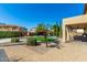Covered patio with pavers, landscaped yard, and a pool in the background at 7156 S Forest Ave, Gilbert, AZ 85298