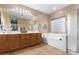 Large bathroom with double sinks, a soaking tub, and a shower at 7156 S Forest Ave, Gilbert, AZ 85298