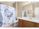 Bathroom with shower/tub combo and a floral shower curtain at 7156 S Forest Ave, Gilbert, AZ 85298