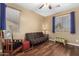 Cozy bedroom with wood floors, a comfortable bed, and a ceiling fan at 7156 S Forest Ave, Gilbert, AZ 85298