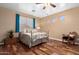 Elegant bedroom with a metal bed frame and hardwood floors at 7156 S Forest Ave, Gilbert, AZ 85298