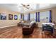 Game room with sectional sofa, recliner, air hockey table, and hardwood floors at 7156 S Forest Ave, Gilbert, AZ 85298