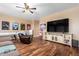 Game room with large TV, recliner, and media console at 7156 S Forest Ave, Gilbert, AZ 85298