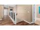 Hardwood floor hallway with white trim and iron railings at 7156 S Forest Ave, Gilbert, AZ 85298