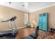 Home gym with hardwood floors and a treadmill at 7156 S Forest Ave, Gilbert, AZ 85298