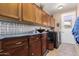 Laundry room with washer, dryer, and ample cabinet space at 7156 S Forest Ave, Gilbert, AZ 85298