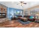 Relaxing living room with stone fireplace, hardwood floors, and sectional sofa at 7156 S Forest Ave, Gilbert, AZ 85298