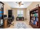 Home office with built-in bookcases, desk, and comfortable chair at 7156 S Forest Ave, Gilbert, AZ 85298