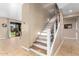 Elegant staircase with wood and white risers, iron spindles, and views to backyard at 7156 S Forest Ave, Gilbert, AZ 85298