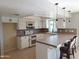 Bright kitchen with white cabinets, tile counters, and breakfast bar at 1829 E Decatur St, Mesa, AZ 85203