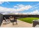 Backyard featuring desert landscaping, artificial grass, and a relaxing fire pit area at 20025 W Madison St, Buckeye, AZ 85326