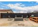 Spacious backyard with fire pit, rocking chairs, and desert landscaping at 20025 W Madison St, Buckeye, AZ 85326