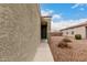 The house's front entrance has an arched entrance, stone landscaping, and a small bush at 20025 W Madison St, Buckeye, AZ 85326