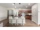 Well-lit kitchen with island, modern appliances, and beautiful hanging lights at 20025 W Madison St, Buckeye, AZ 85326